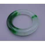 A jade bangle. 9 cm exterior diameter and 6 cm interior diameter.