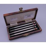 A cased set of four sterling silver bridge pencils.