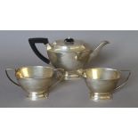 A silver three-piece tea set. The teapot 28 cm long. 933.6 grammes total weight.
