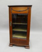 An Edwardian music cabinet. 47 cm wide.