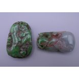 Two carved jade pendants. The largest 5.5 cm high.