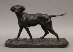 A patinated bronze model of a dog. 31 cm wide.