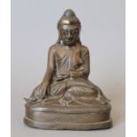 An antique, possibly 18th century, bronze model of Buddha, with inset glass eyes. 16 cm high.