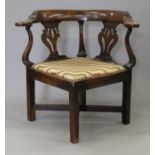 A Georgian mahogany corner armchair. 78 cm wide.