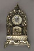 An unmarked white metal mantle clock. 49 cm high.