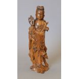 A 19th century carved wooden model of Guanyin. 26 cm high.