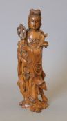 A 19th century carved wooden model of Guanyin. 26 cm high.