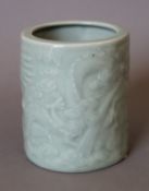 A Chinese celadon porcelain brush pot. 12 cm high.