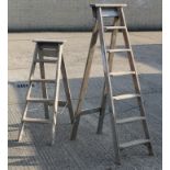 Two vintage wooden step ladders.