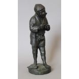 A Japanese bronze model of a man with a pipe. 30 cm high.