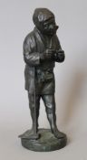 A Japanese bronze model of a man with a pipe. 30 cm high.