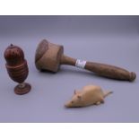 A carved wooden mouse, a mallet and a carved coquilla nut sifter. The latter 9.5 cm high.