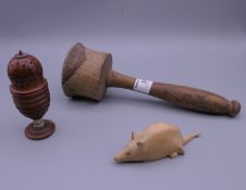 A carved wooden mouse, a mallet and a carved coquilla nut sifter. The latter 9.5 cm high.