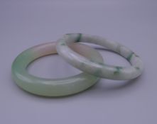Two jade bangles. Each approximately 7.5 cm exterior diameter.