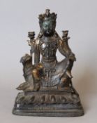 A bronze model of Buddha seated astride a dog-of-fo. 22 cm high.
