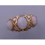 An 18 ct gold opal and diamond ring. Ring size N/O. 5.5 grammes total weight.