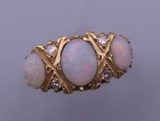 An 18 ct gold opal and diamond ring. Ring size N/O. 5.5 grammes total weight.