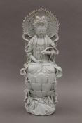 A 19th century Chinese blanc de chine model of Buddha, the reverse with impressed seal mark. 39.