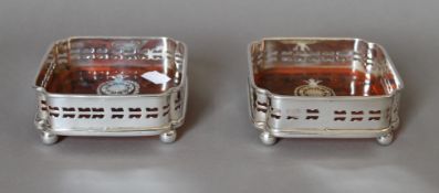 A pair of silver plated coasters. 12 cm wide.