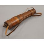 A leather cased telescope.