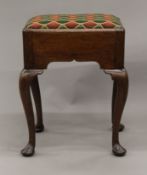 A 19th century oak upholstered stool. 43 cm wide.