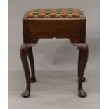 A 19th century oak upholstered stool. 43 cm wide.