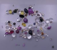 A bag of gemstones, including diamonds, sapphires, citrines, etc.