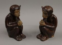 A pair of Chinese pottery monkeys. 16 cm high.