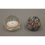 Two Italian millefiori paperweights. The largest 5.5 cm high.