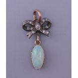 An unmarked gold diamond and opal pendant. 2.5 cm high.