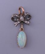 An unmarked gold diamond and opal pendant. 2.5 cm high.