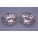 A pair of silver pierced dishes. 10 cm diameter. 76 grammes.