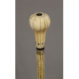 A 19th century carved whalebone walking stick with carved ivory handle. 91 cm long.