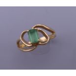 An 18 K gold and emerald ring. Ring size M. 3 grammes total weight.