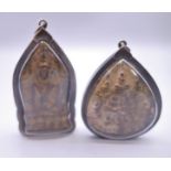 Two Tibetan icon pendants. The largest 7 cm high.