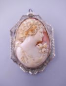 A 10 K white gold mounted cameo brooch. 5 cm high.