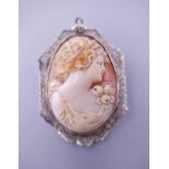 A 10 K white gold mounted cameo brooch. 5 cm high.