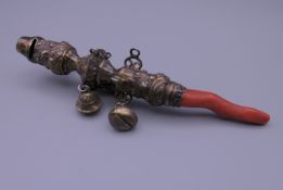 A Victorian silver gilt rattle. 15 cm long. 63.1 grammes total weight.