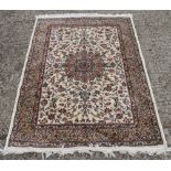 An ivory ground full pile Kashmir shorbass medallion design rug.