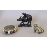 A Chinese white metal inlaid wooden model of a boy on a buffalo,