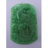 A carved jade pendant with gold suspension loop. 6.5 cm high.