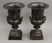 A pair of classical style bronze urns. 37 cm high.