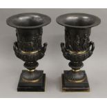 A pair of classical style bronze urns. 37 cm high.