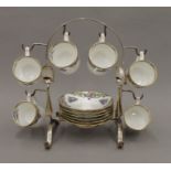 An early 20th century porcelain coffee set on a silver plated stand. 22 cm high.