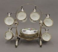 An early 20th century porcelain coffee set on a silver plated stand. 22 cm high.