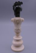 A 19th century ivory and marble chess piece. 10 cm high.