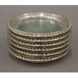 Six sterling silver mounted glass coasters. 9.5 cm diameter.