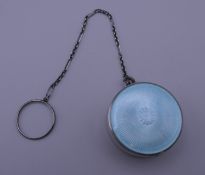 A silver and blue enamel pill box on chain. Pill box 3 cm diameter.