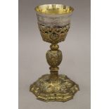 A 17th century silver gilt and brass chalice. 18.5 cm high.