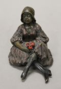 A cold painted bronze model of a girl and rose. 8 cm high.